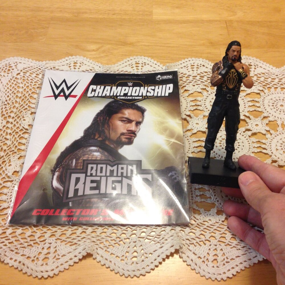 WWE Wrestling Roman Reigns action figure and collector's magazine